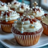 Vanilla mini cupcakes frosted with creamy buttercream and decorated with fondant rosary toppers for First Communion.  