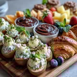 Vibrant Easter brunch platter featuring classic deviled eggs, seasonal fruit, and assorted pastries, perfect for sharing.  