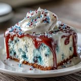 Vibrant Patriotic Poke Cake layered with fruity gelatin and decadent white chocolate topping.