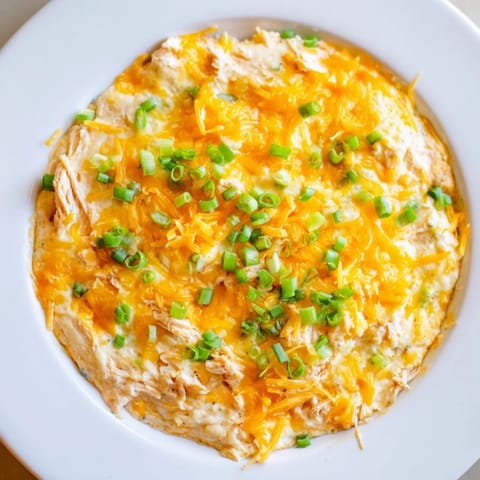 A close-up shot of creamy Buffalo Chicken Dip, boasting melted cheese and shredded chicken.