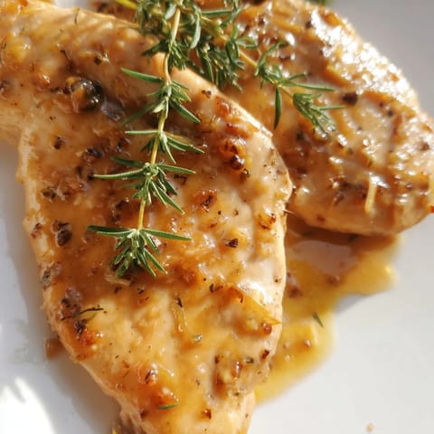 Juicy Honey Dijon Chicken Skillet with tender herbs, ready to serve over creamy mashed potatoes for a cozy weeknight dinner.