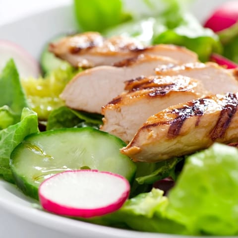 Tender grilled chicken breast is served over a colorful bed of mixed greens, sliced radish, and creamy avocado in this light Spring Detox Chicken Salad.