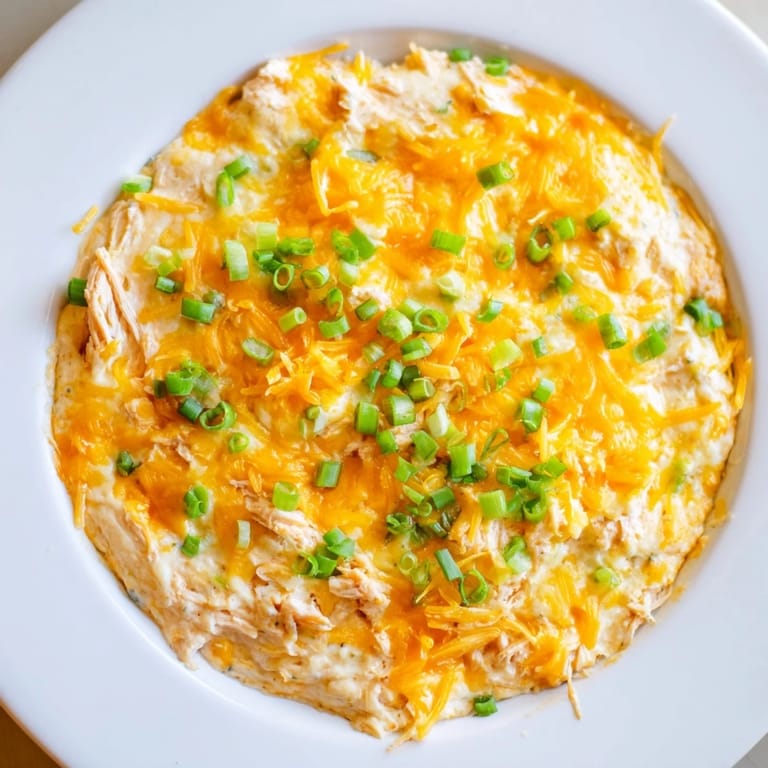 A close-up shot of creamy Buffalo Chicken Dip, boasting melted cheese and shredded chicken.