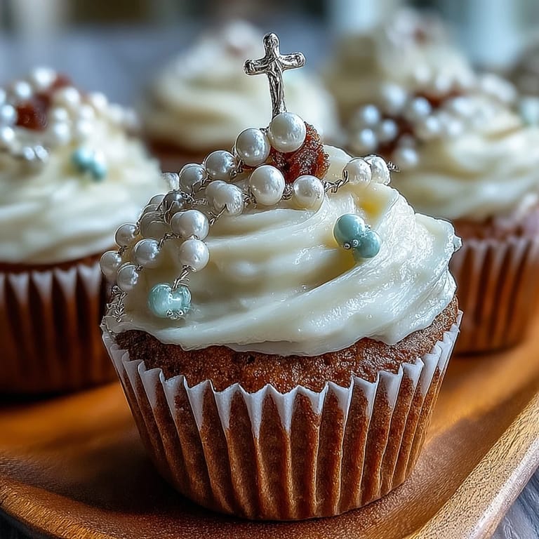 Adorable mini cupcakes topped with smooth vanilla buttercream and delicate fondant rosary toppers for First Communion.